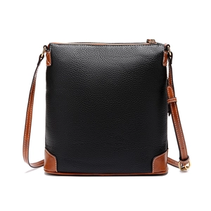 Close-up of pebble leather texture on classic two-tone black and brown crossbody bag