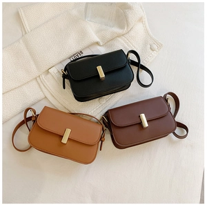 Detailed flat lay of vintage saddle bags in black, brown, and caramel with gold buckles