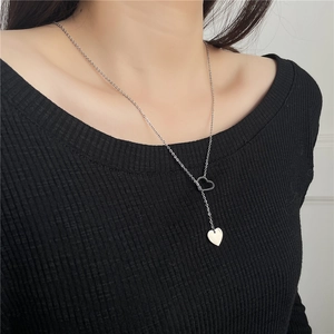 Silver double heart pendant necklace shown on model with polished stainless steel finish