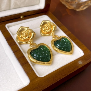 Vintage gold rose earrings with green heart charms in a luxury wooden jewelry gift box