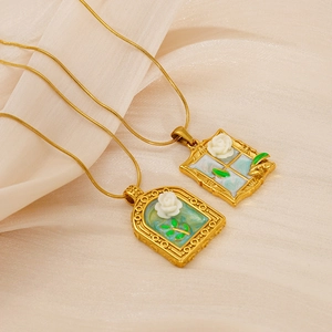 Detail of vintage oil painting style flower pendants on golden stainless steel chains