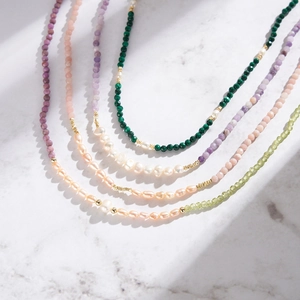 Detailed macro view of S925 silver necklaces with colorful opal beads and freshwater pearls