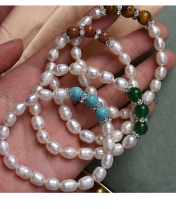 Detailed close-up of natural pearl bracelets with turquoise, agate, and tiger eye stones
