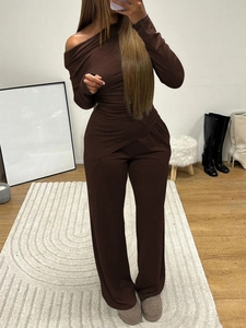 Elegant deep brown long sleeve off-shoulder jumpsuit with wide leg silhouette on model