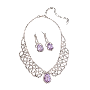 Silver jewelry set with purple teardrop crystals and sparkling rhinestones on white background