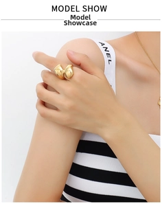 Detail shot of irregular double-lobed 18K gold plated ring with abstract fluid design