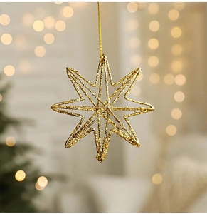 Close-up of sparkling gold star Christmas ornament with glitter finish on festive tree