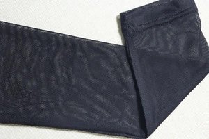 Close-up of semi-transparent black fine mesh fabric with detailed stitching and texture