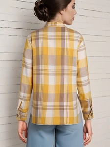 Back view of women's loose long sleeve plaid shirt in yellow and white check pattern