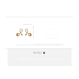 Detail view of gold-plated ball earrings showing brass material and silver needle specs