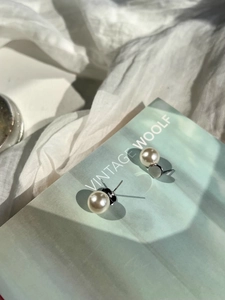 Detailed macro view of S925 sterling silver earring post with hallmark and round white pearl