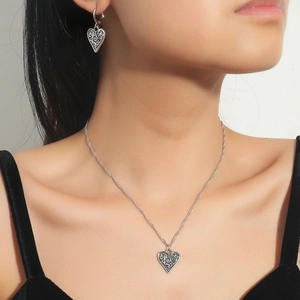 Vintage silver heart jewelry set with engraved necklace and matching earrings