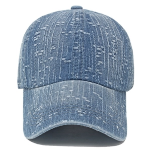 Close-up of blue denim baseball cap with vertical distressed stripes and reinforced brim