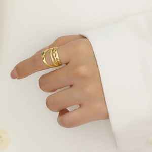 Irregular double-layered silver ring with green gemstone on a model's hand