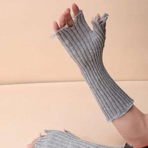 Gray knitted fingerless arm sleeves with trendy distressed ripped details for autumn