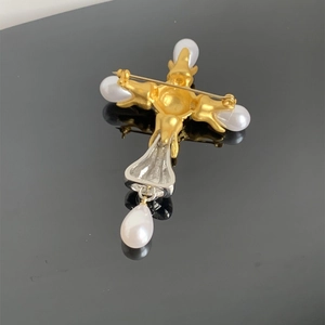 Detailed back view of vintage silver and gold cross brooch with water drop pearls
