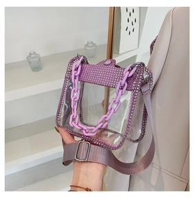 Detailed macro of the purple rhinestone trim and thick chain on a transparent PVC handbag