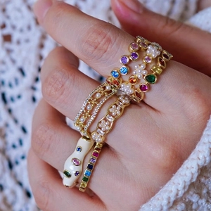 Rainbow gemstone and pearl stackable rings set with snake enamel design on hand