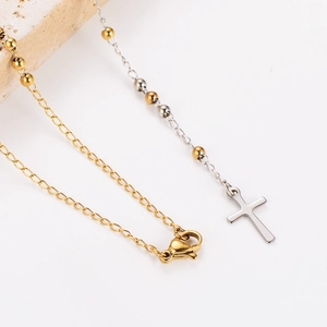 Detail of vintage portrait medal necklace with cross tassel on stone prop