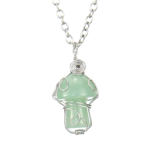 Detail of hand-wrapped silver wire mushroom pendant with a polished light green gemstone