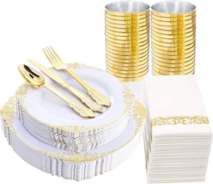 Close-up of white embossed disposable plates and golden plastic cutlery set