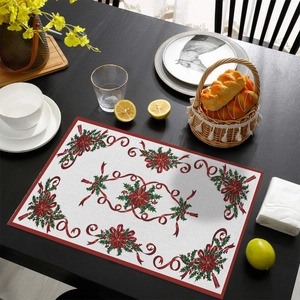 Close-up of a festive Christmas placemat with poinsettia pattern and holiday table settings