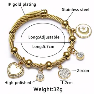 Bracelet ajustable en acier doré tressé avec breloques œil et pendentifs en cœur