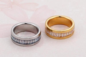 Close-up of gold and silver stainless steel rings with full pavé cubic zirconia inlay