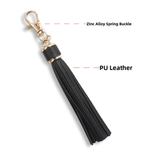 Detail of black PU leather tassel keychain with gold-tone zinc alloy spring clasp