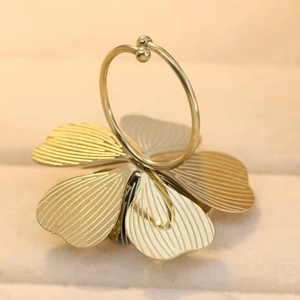 Macro shot of gold-plated stainless steel four-leaf clover ring with textured petals