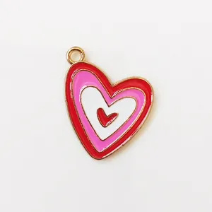 Macro view of multi-layer colorful enamel heart pendant with golden metal edges