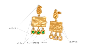 Detail of vintage textured rectangle earrings with green glass stone and zircon stones