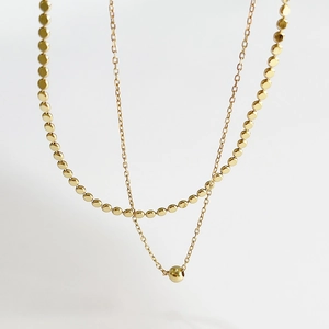 Double-layered 925 silver gold-plated necklace featuring flat beads and a round pendant