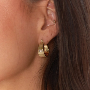 18K gold plated C-shaped ridged earrings with square zircon stone worn by a model