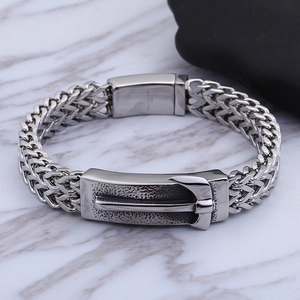 Detail of men's punk steel bracelet with double-layer woven chain and buckle clasp