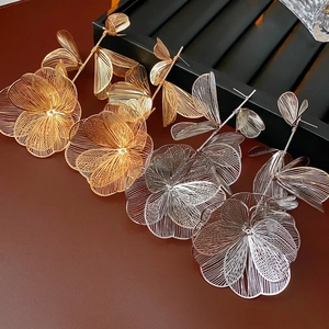Dramatic hollow mesh flower earrings in gold and silver finish for a bold fashion statement