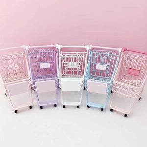 Row of five colorful mini desktop storage baskets in pink, purple, white, and blue tones