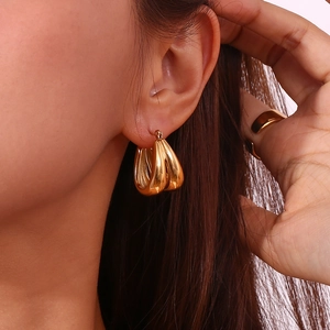 Polished 18K gold-plated stainless steel double-layered water drop hoop earrings on model