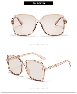 Detail view of brown square sunglasses with stylish golden metal chain temples