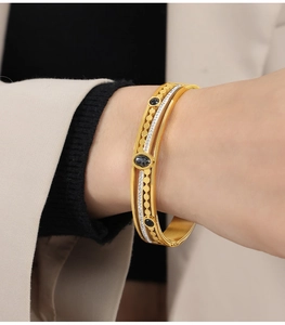 Detailed view of vintage gold plated double layer cuff with black stones and zircon inlay