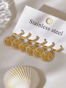 Detailed view of six gold-plated stainless steel earrings with sparkling zirconia stones