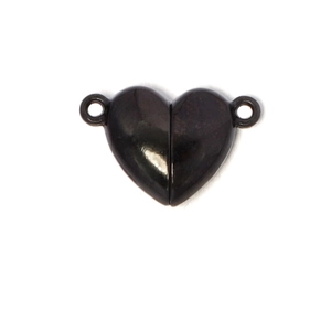 Macro shot of black heart-shaped magnetic clasp jewelry connector with metallic finish