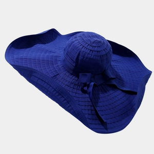 Detailed texture of blue wide-brim sun hat featuring a large decorative bow