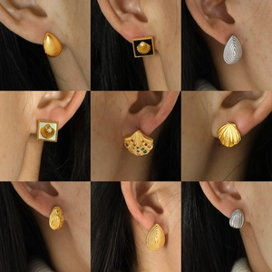 Elegant shell-style titanium earrings in gold and silver, showcased on models in a 3x3 grid