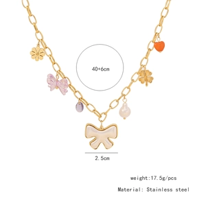 Detailed view of stainless steel necklace with colorful bow, heart and floral pendants