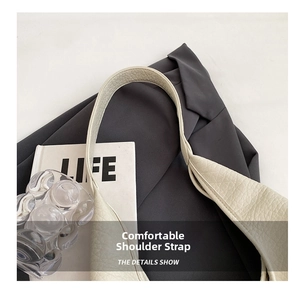 Close-up of white lychee texture faux leather strap with precise stitching on high-end tote bag