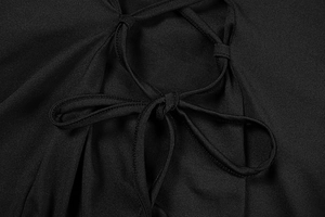 Detailed view of the elegant black dress featuring a criss-cross lace-up waist design