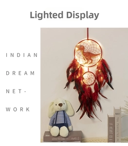 Detail of red dinosaur dream catcher with LED lights and feathers for kids room