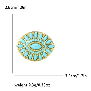 Detail view of turquoise rhinestone brooch with dimensions 2.6cm by 3.2cm and 9.3g weight