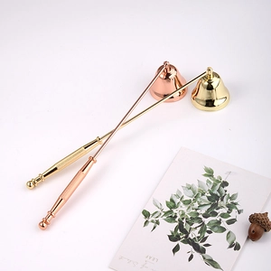 Golden and rose gold candle snuffer set with long handles on white background